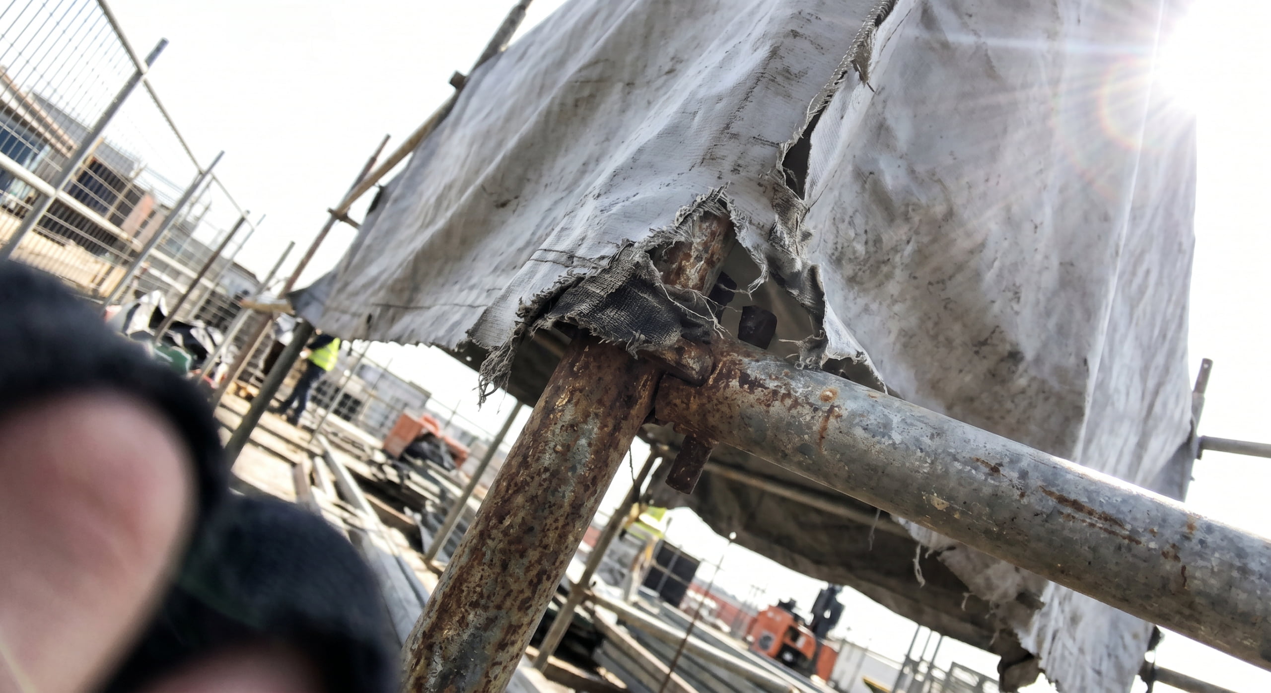 Close-up of wind flutter damage on PVC fabric shelter